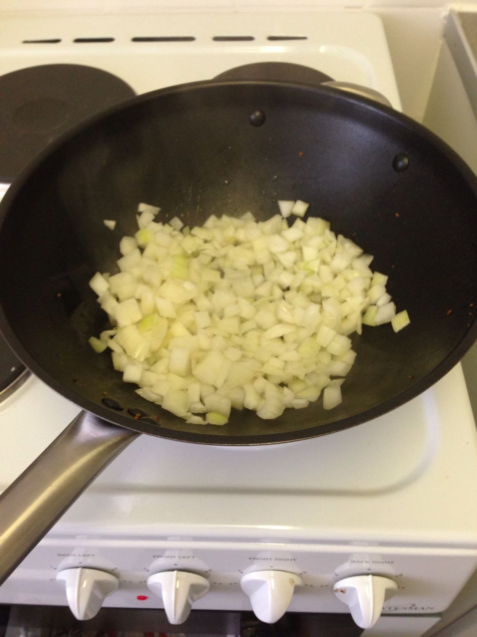 Once done (5 mins) transfer to a plate. Next in the same pan/wok add another tablespoon of olive oil and stir fry the onion on a medium heat.