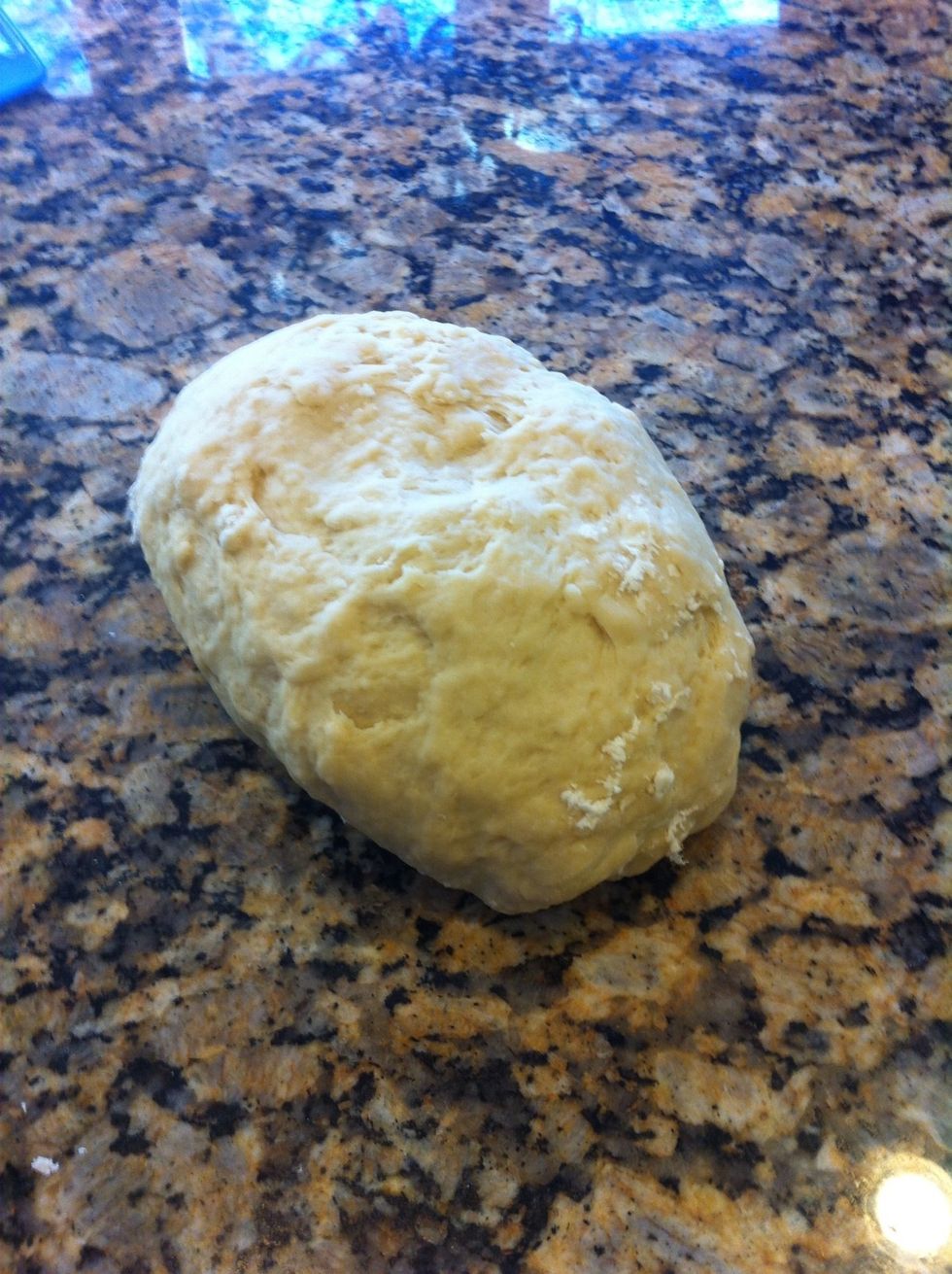 Once dough has formed and still a little sticky, turn out on counter top and start kneading