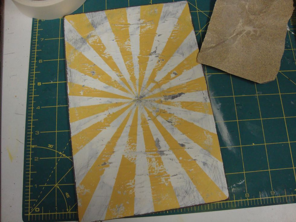 Once dried, take sandpaper to the invitation. Don't forget around the edges and corners!