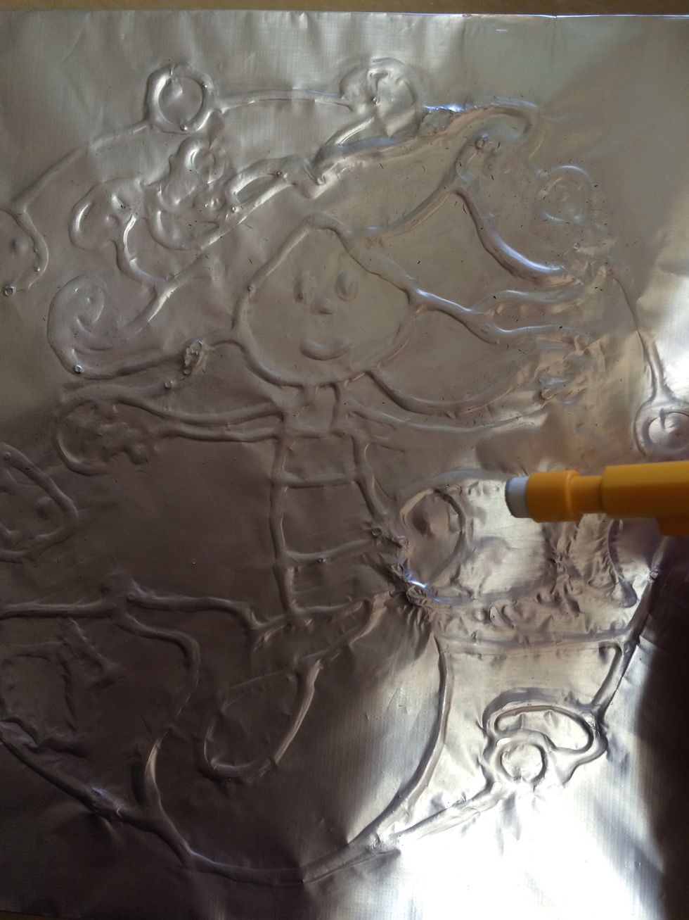 Once dry cover with tin foil/alfoil. And gently but persistently rub around your glue. You need to rub quite a lot until the alfoil stretches and you can see your image clearly.