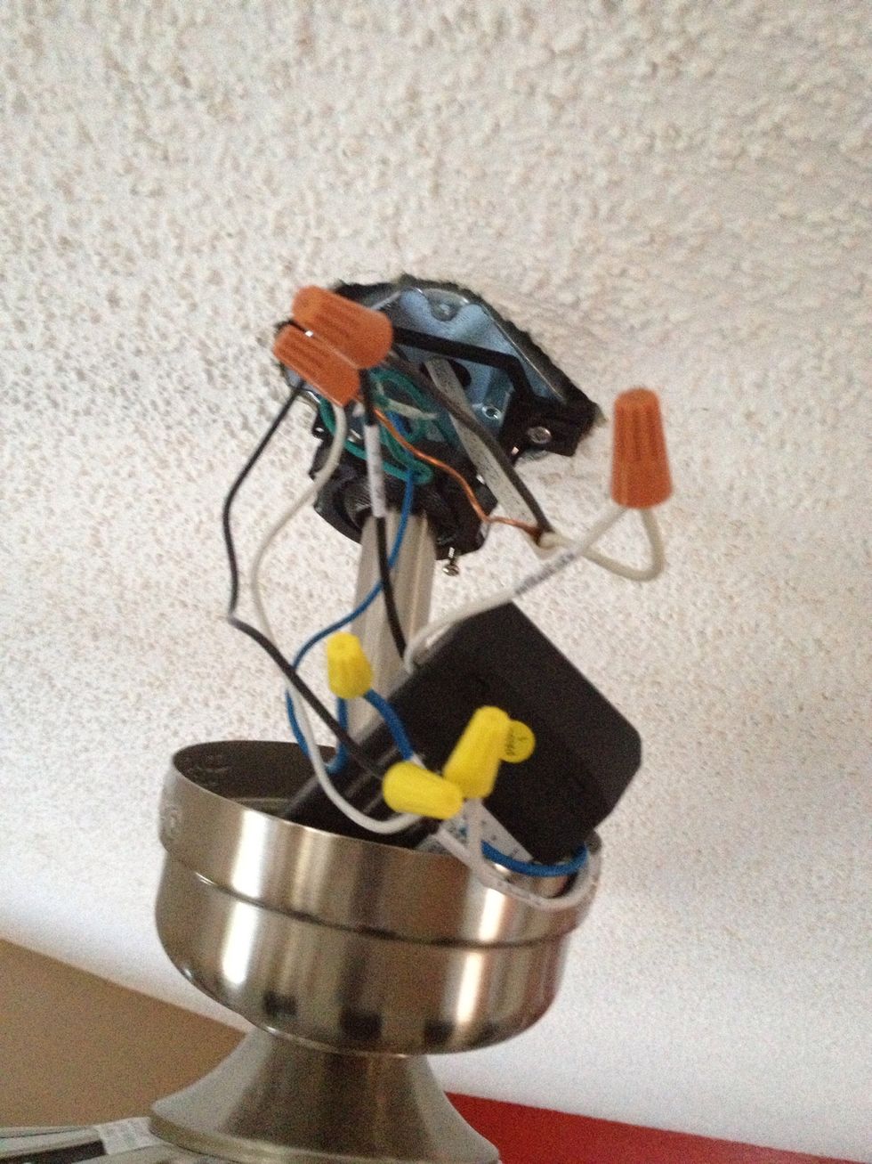 Once everything is connected, position the box in the bracket