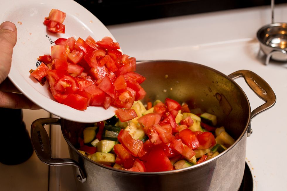 Once everything is hot, add the tomatoes.