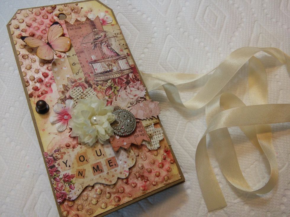 Once folded into an accordion, wrap the ribbon around the back, and come forward on the left side.