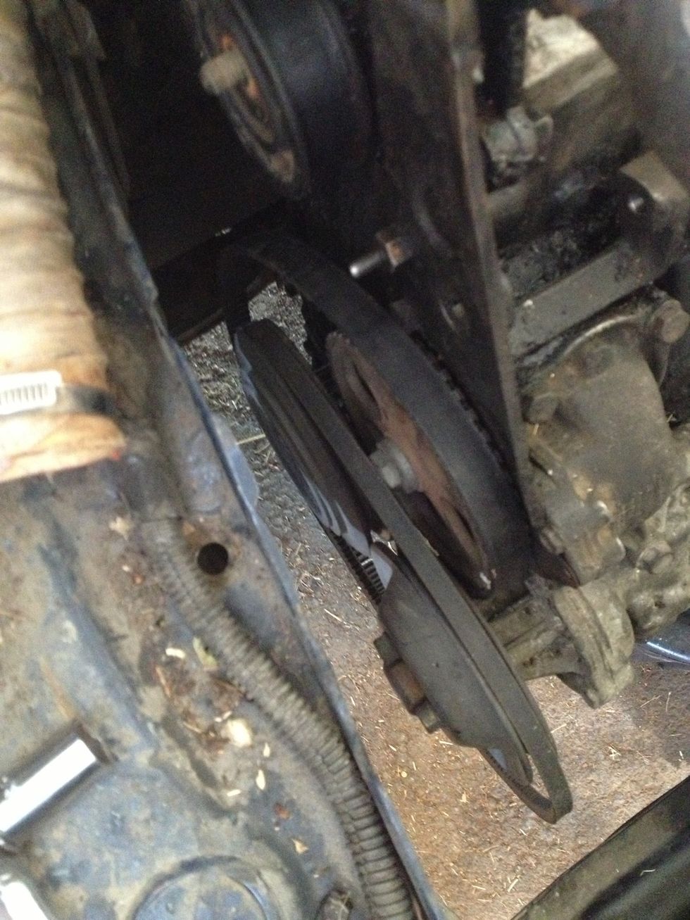 Once freed, rest the belt on the lower pulleys