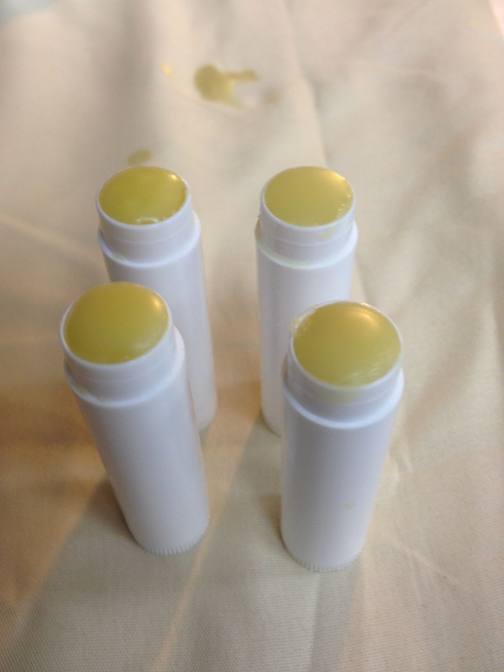 Once fully cooled, wipe excess balm from off the tubes with a towel and cap them.