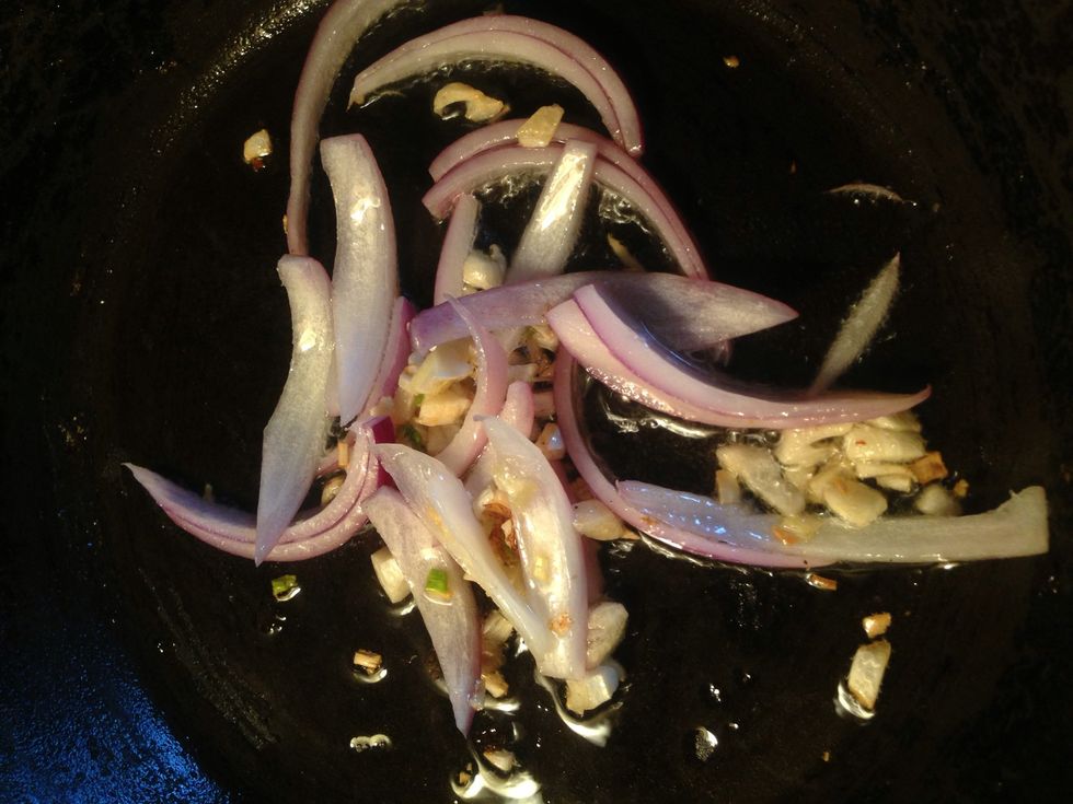 Once garlic is browned, add your onions and wait for about 30 seconds before adding your cooked chicken
