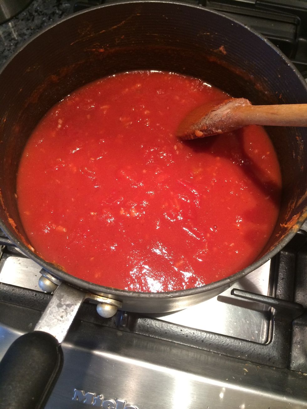 Once garlic is cooked add in tin of chopped tomatoes. Let simmer and add fajita powder mix and salt and pepper to taste.