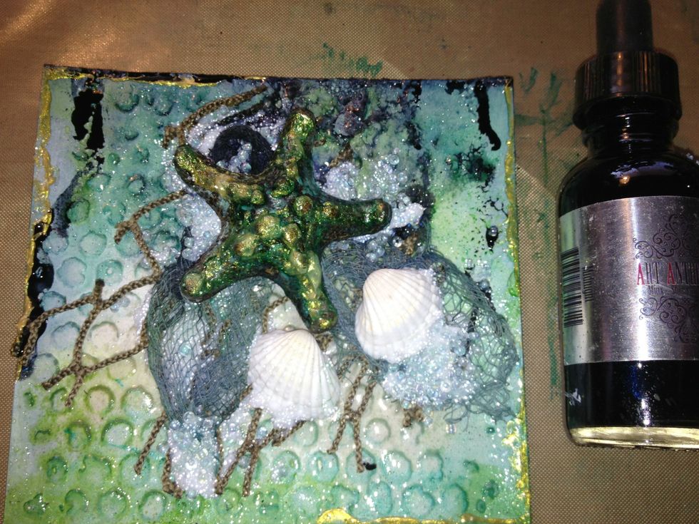 Once gesso is dry I applied Colorations spray in Grass and Marlin drying in between coats of spray. and topped it off with Metal Effects in Gold. I also applied Gold to the edges of the card.