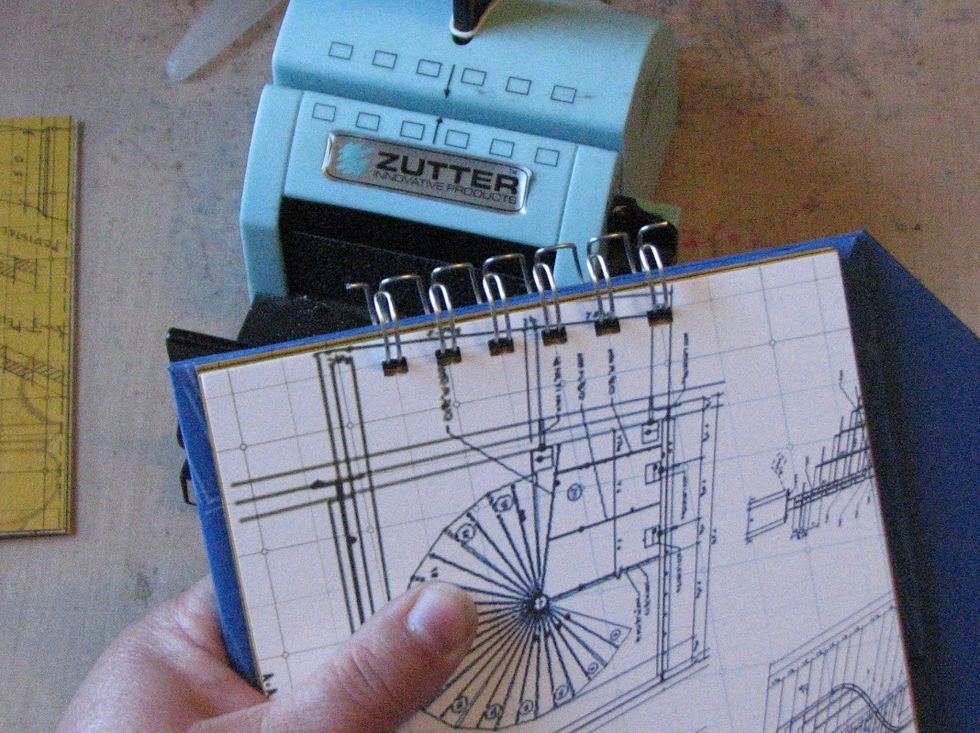 Once holes have been punched in the album base, cover and pages, insert a piece of o-wire into the base, add the front cover and pages.
