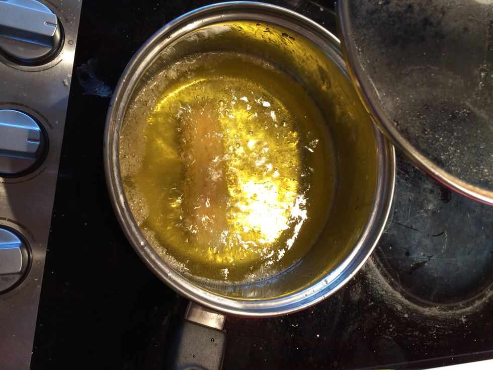 Once hot, place the cheese stick into the oil and fry until golden brown on the outside.