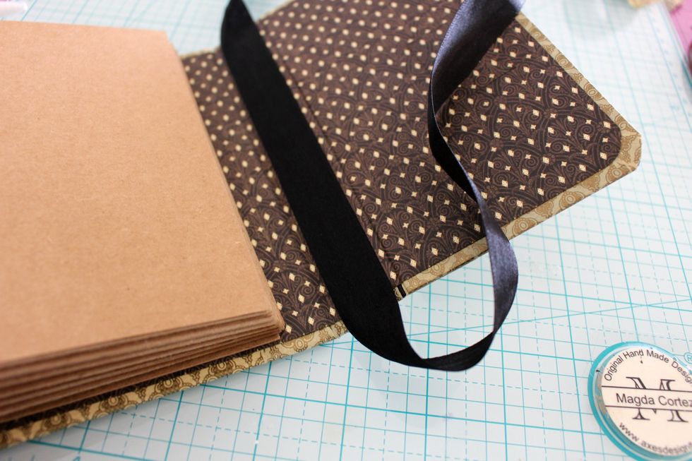 Once I add Washi Tape to all the sides I cover the interior with the Well Traveled paper and with double sided tape add the Black Ribbon.