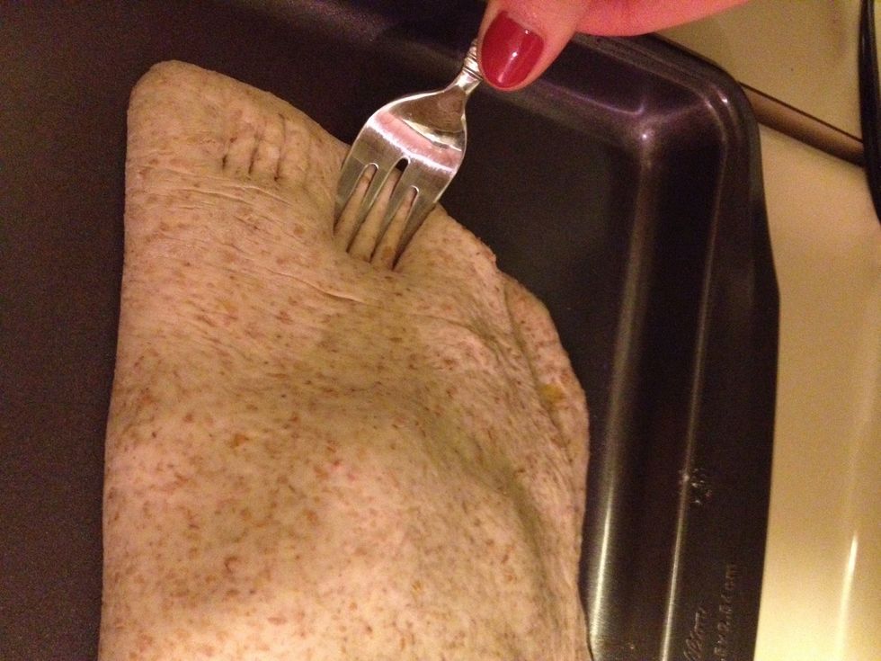 Once ingredients are placed, flip over the other half of dough overtop the ingredients. Next, use a fork to seal the top and bottom pieces of dough. Be careful not to tear the dough, it's easy to do.