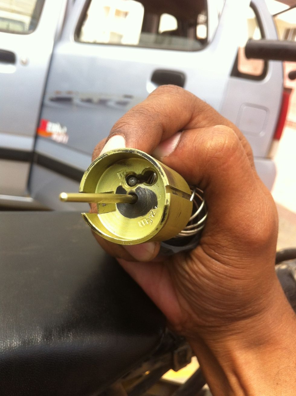 Once inserted through the big hole slide the cable head into the smaller hook slot.