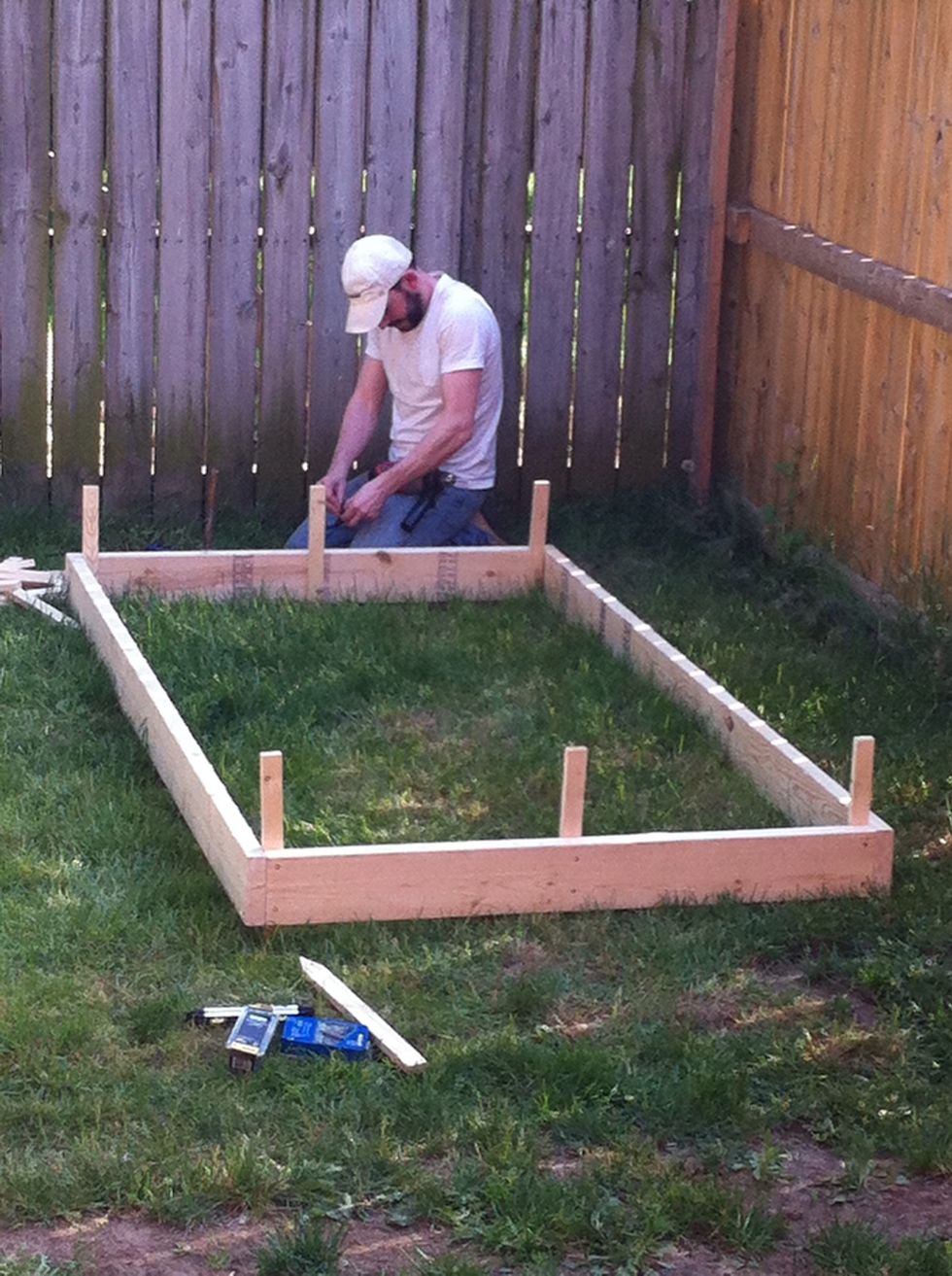 Once it's all square and level and secured in all 4 corners, its time to reinforce. Add 1 stake in the center of each 4- ft board, drilling pilot holes, and screwing to board...