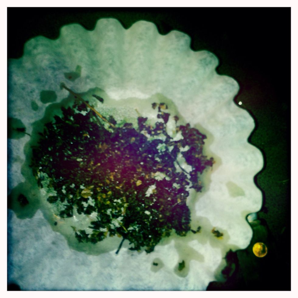 Once it's finally all strained, take your left over herb and squeeze out the rest of the juice, then rinse your measuring cup out, and pour the remaining liquid back into the measuring cup.