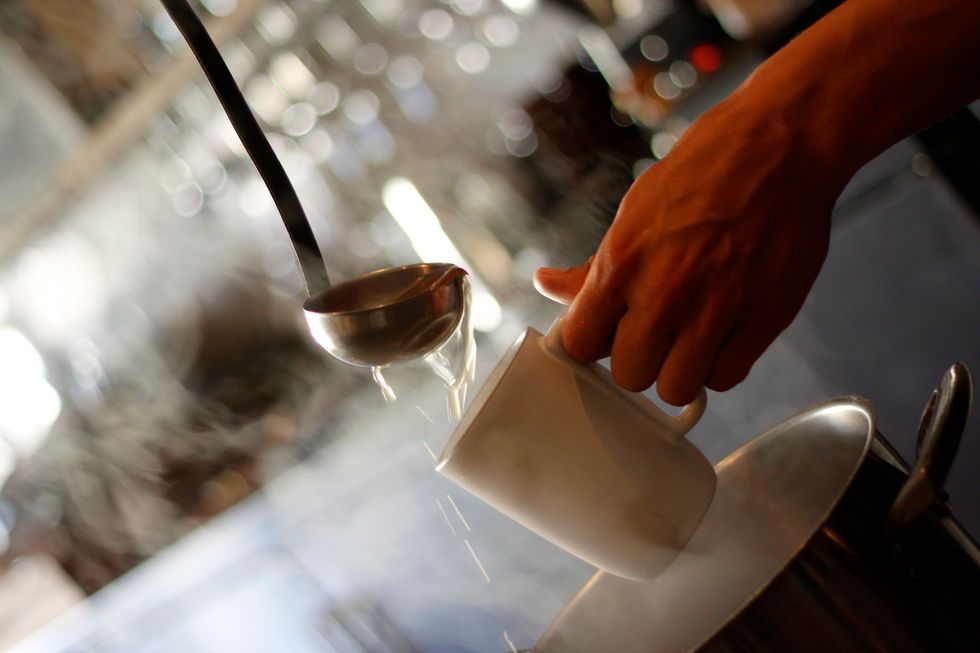 Once it's heated, fill your mug with hot cider.