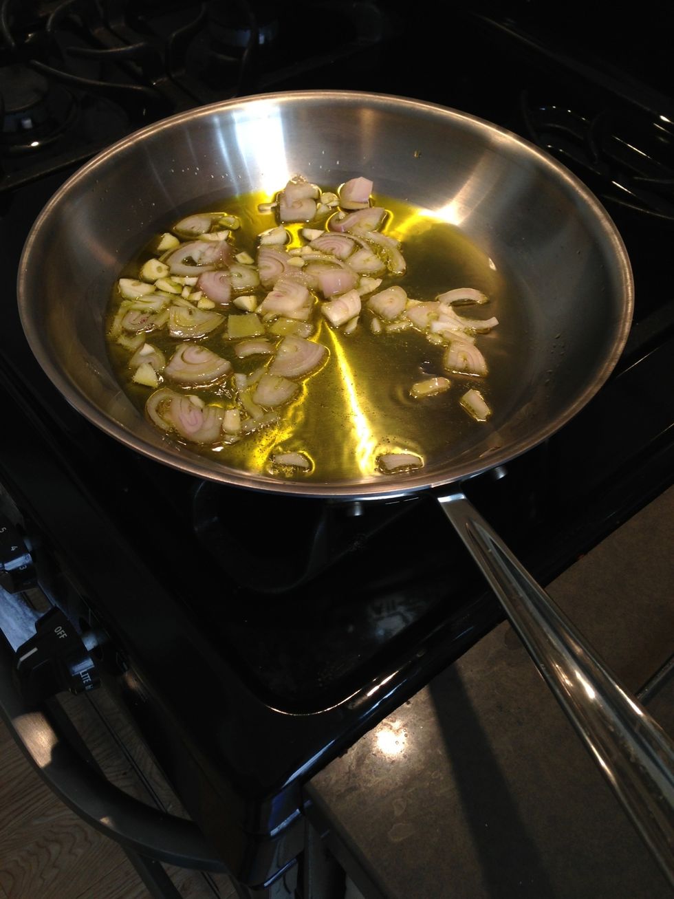Once it's hot, add shallots and garlic. Cook until translucent and lightly browned in places.