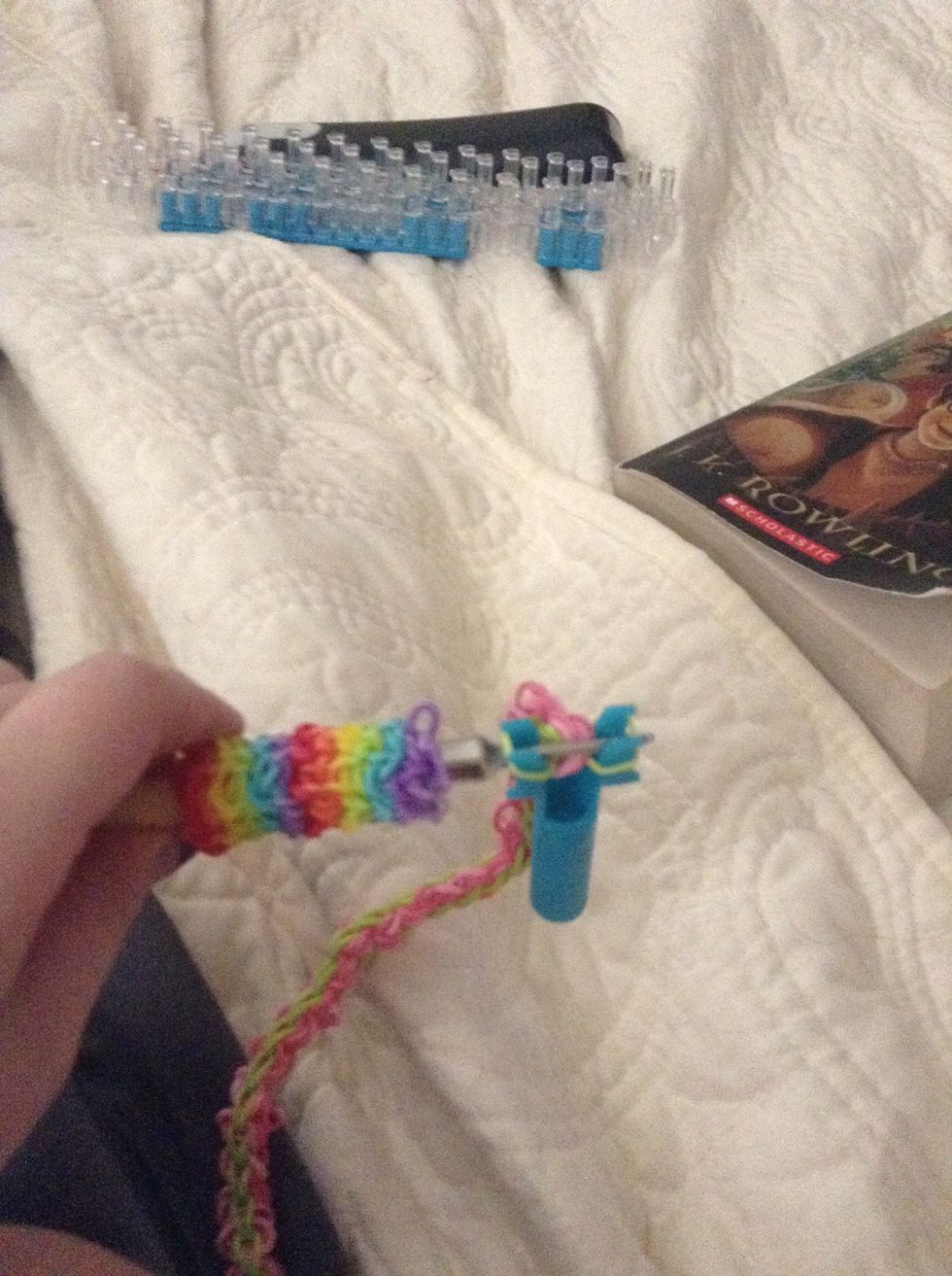 Once it's long enough, tuck your hook under and pull it off the two pegs. Then clasp it together.