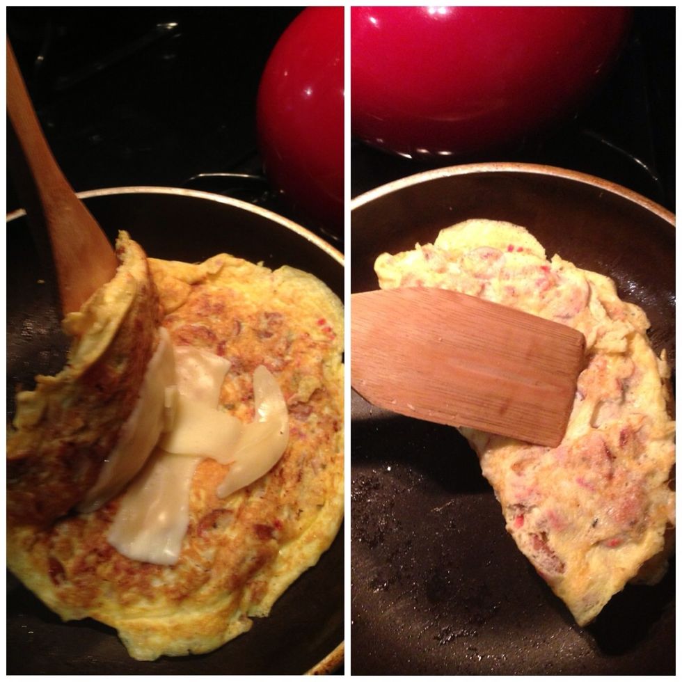 Once it starts to melt, fold the omelette in half and press it together.