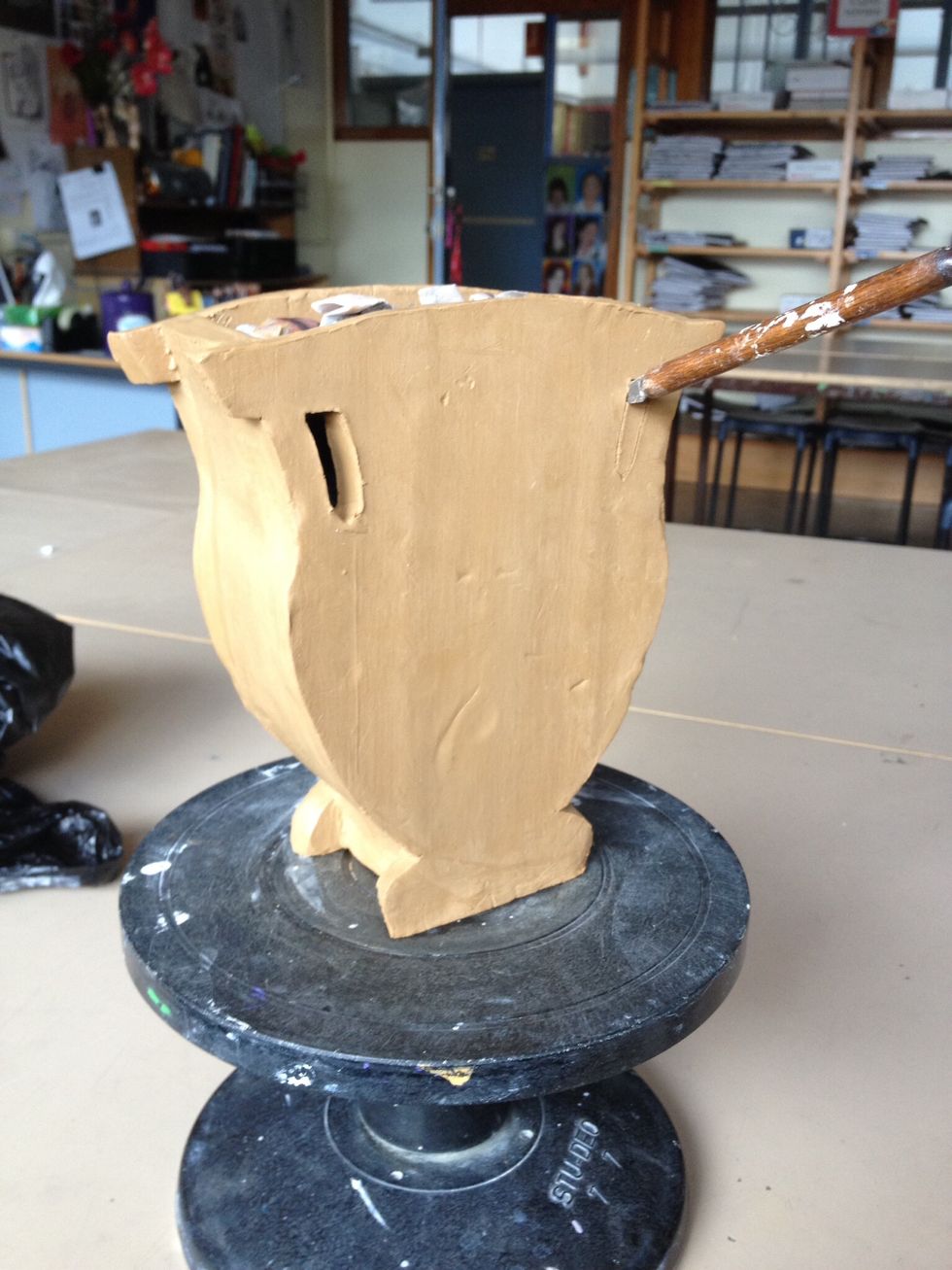 Once leather hard, cut handles or other negative spaces with a fettling or palette knife.