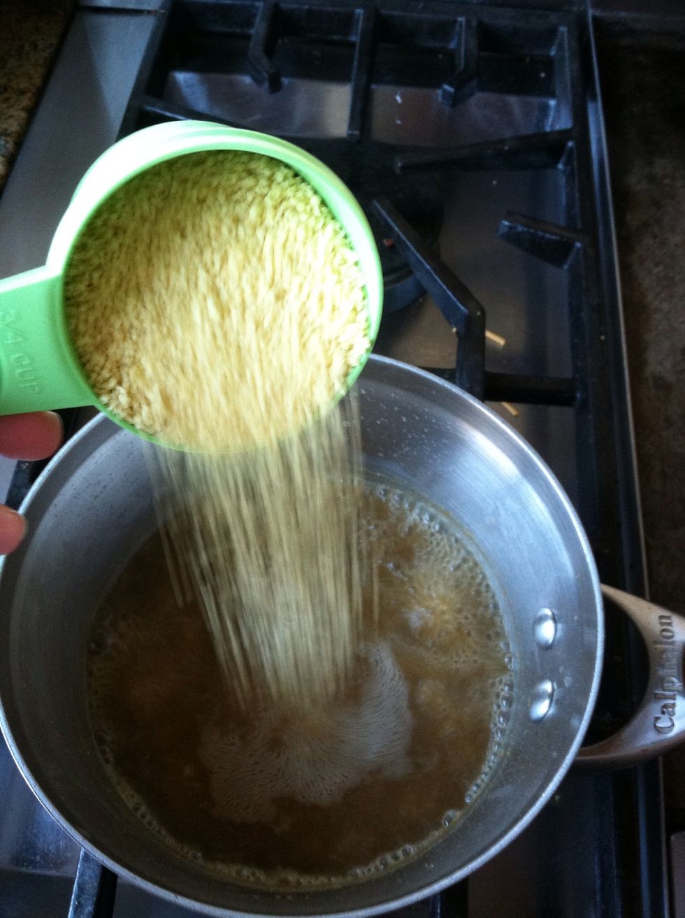 Once mixture comes to a boil remove from heat, pour in couscous and mix then immediately cover