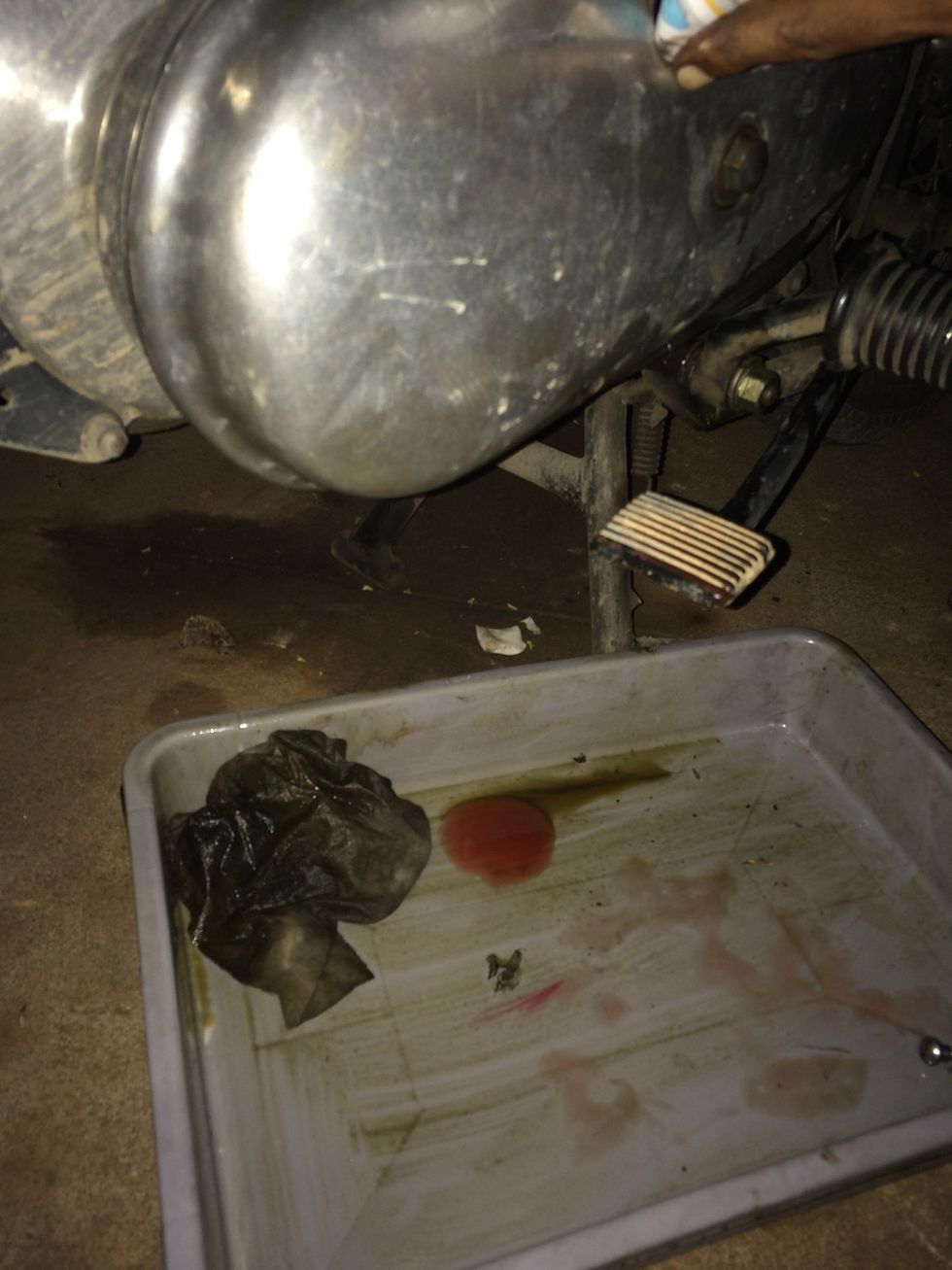 Once oil has dropped out, stop and tighten inspection cap and oil level drain screw