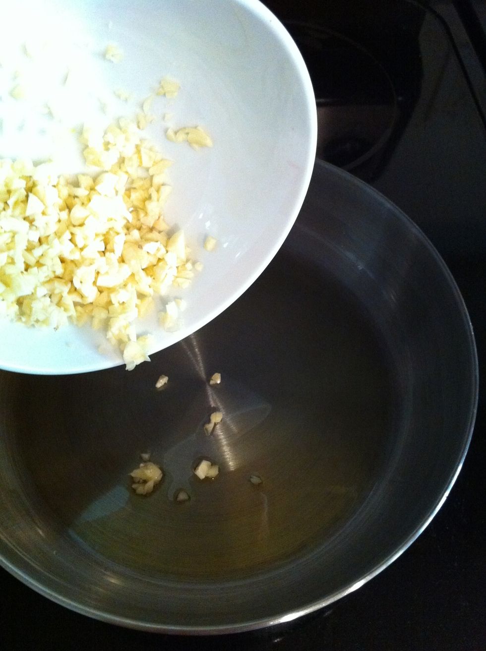 Once olive oil is heated up, add in mince garlic (it should sizzle a little)