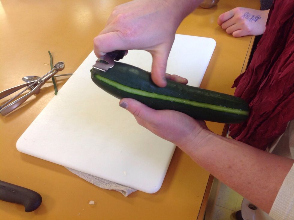 Once one line is made rotate the cucumber and carve out another line. Repeat this to make 5-7 evenly spaced lines. With food everything should always be in odd numbers. It's more visually appealing.