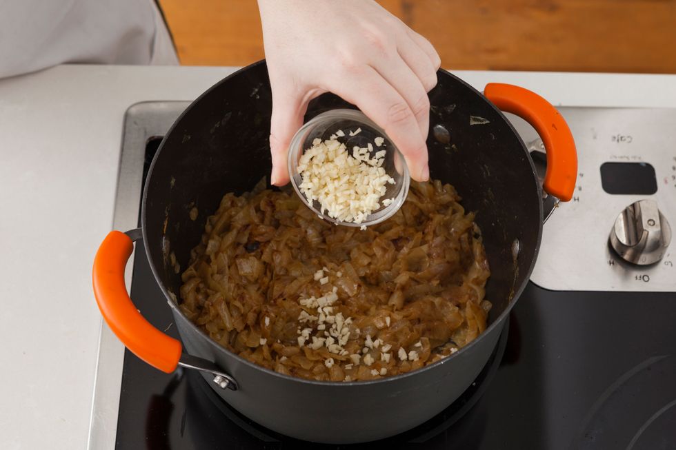 Once onions are caramelized, add minced garlic and saut\u00e9 for 1 minute.