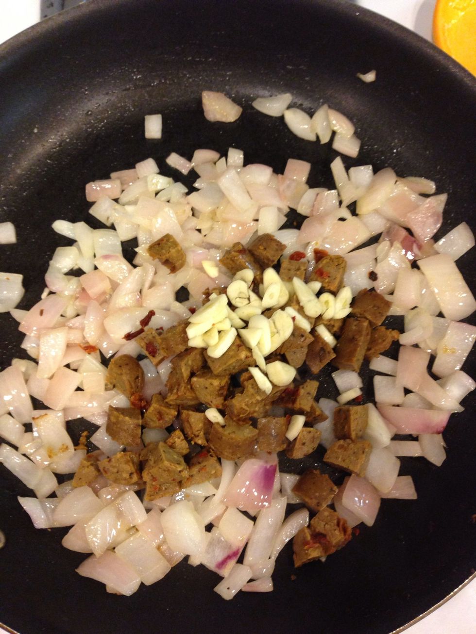 Once onions become translucent, add the garlic and meat.