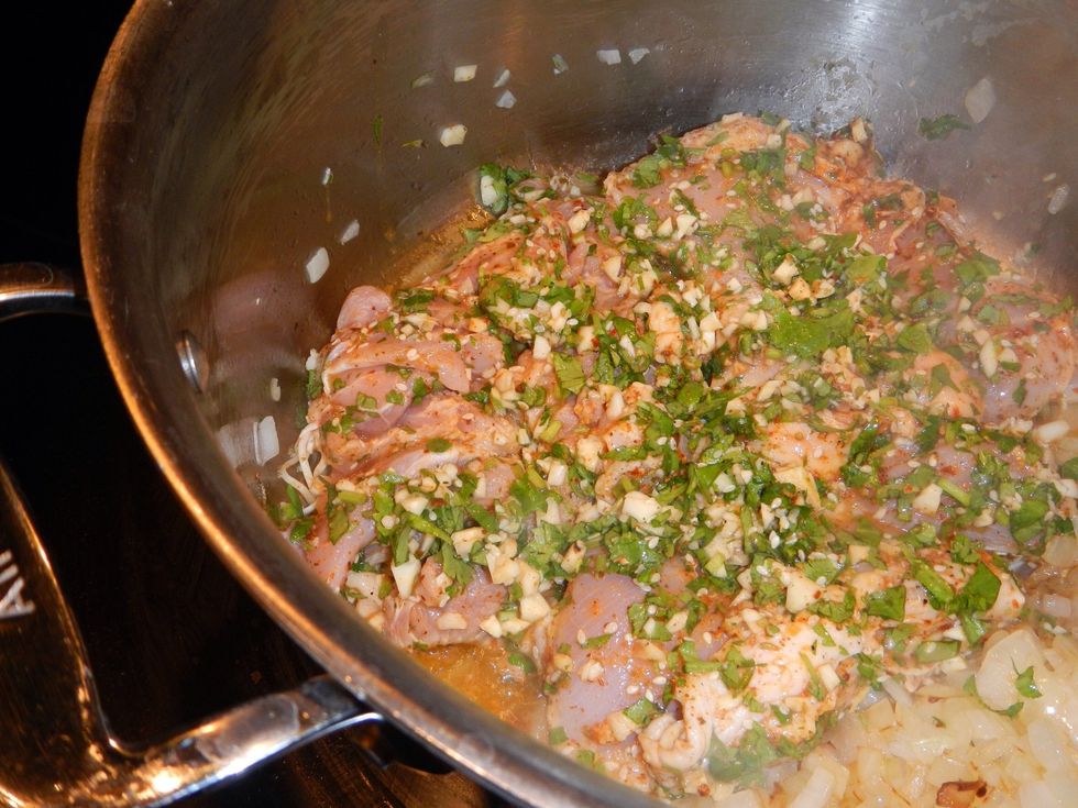 Once onions have just about caramelized, 5 minutes or so, move them off to the side of your pot. Separately add each piece to the pot, so all surfaces touch the bottom. Put onions on top of chicken.
