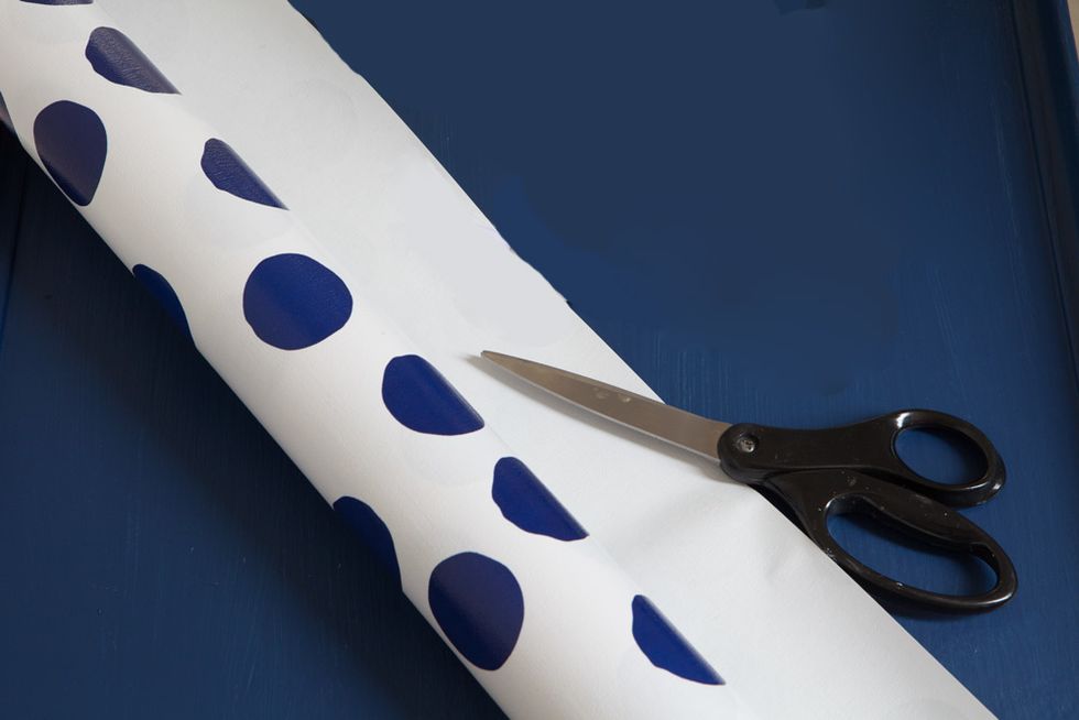Once paint is completely dry. Cut gift wrap about 3 inches larger all around than the table top.