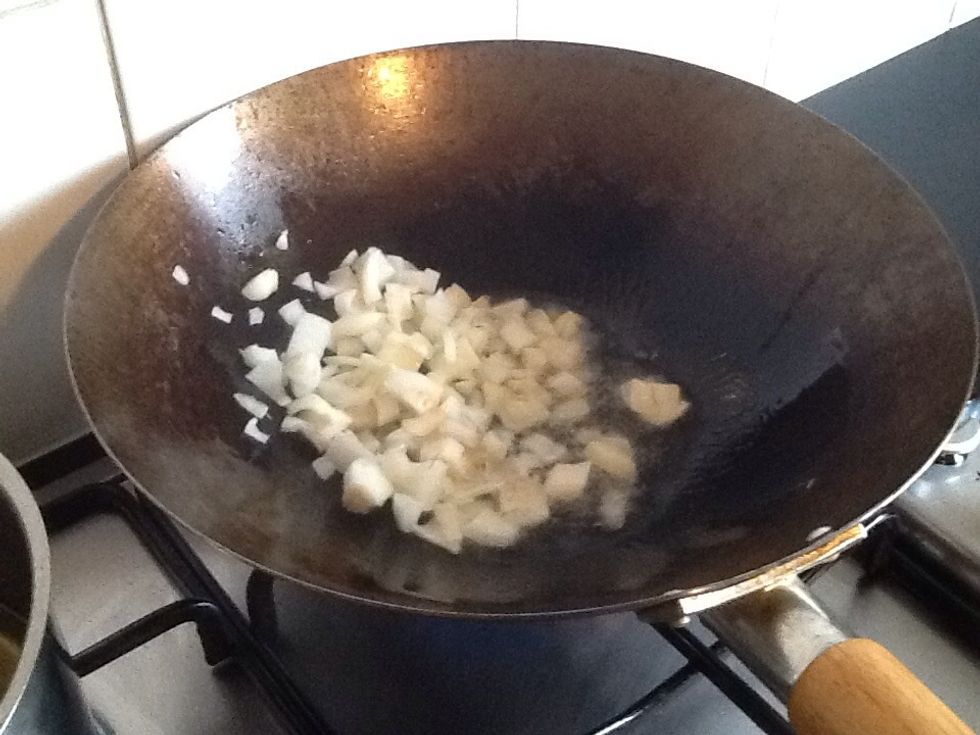 Once pan is at a reasonable heat, place onion and ginger to cook.
