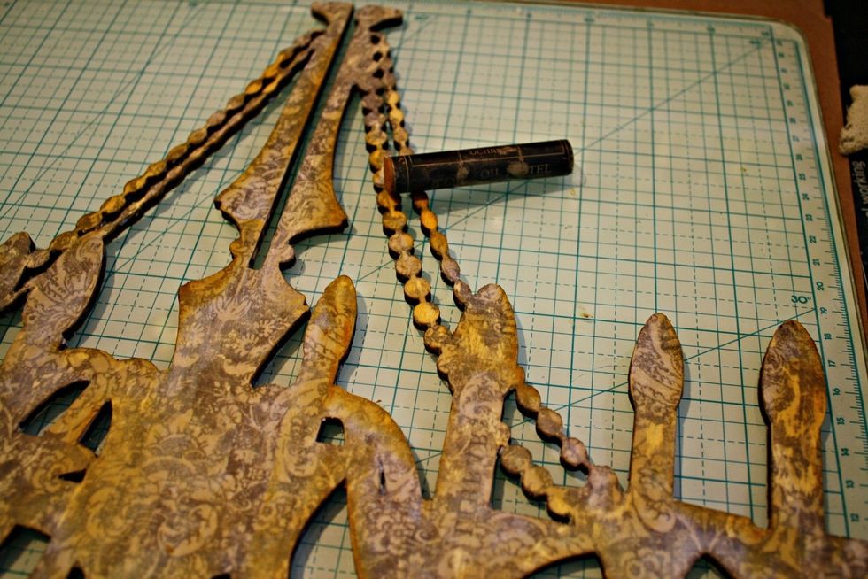 Once paper is removed and piece is sealed with gel, add oil pastels in "ochre" to distress the edges. It will lend a vintage / aged look and fill in any areas the paper design came off.