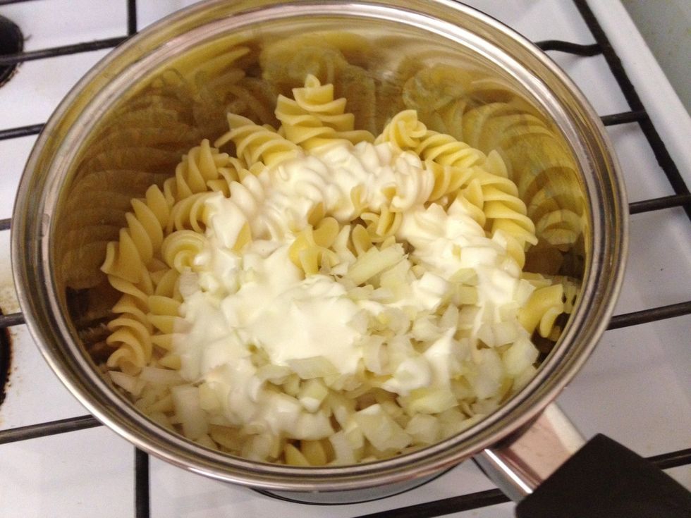 Once pasta is cooked, drain water, then add thickened cream and onion. Stir for a minute or so.