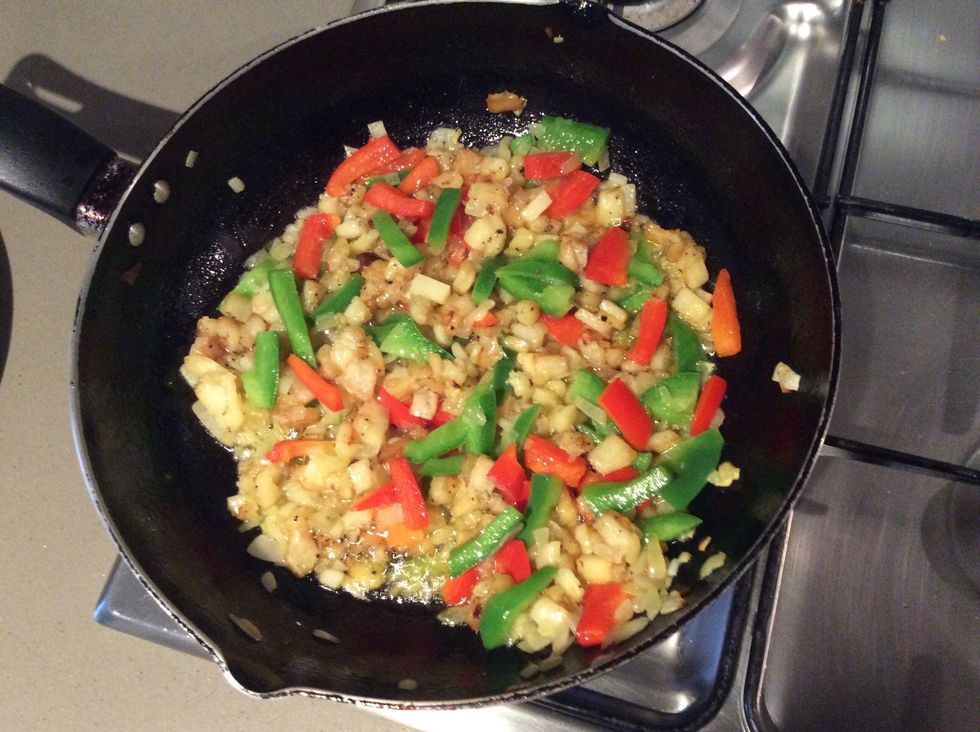 Once potatoes turn brown add peppers to the pan.