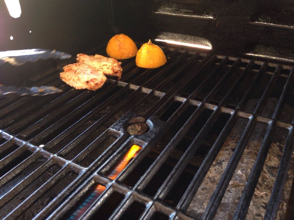 Once preheated and hot, add your chicken skin side down and add your lemon.