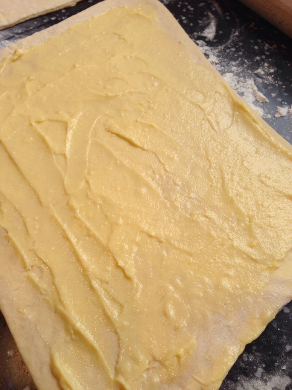 Once rolled out cut the rectangle in to two pieces so that you have 2 rectangles. For cinnamon raisin swirls first cover one of the layers with the Creme Patissiere (thick custard)