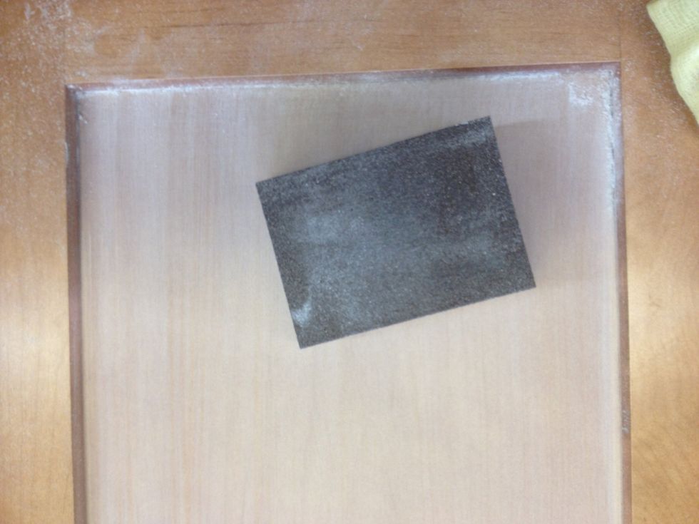 Once sanded, the surface of the panel will be powdery and dull (finished wood). Wipe with your tack cloth to remove any dust. Dust left on the surface = a bumpy chalkboard.