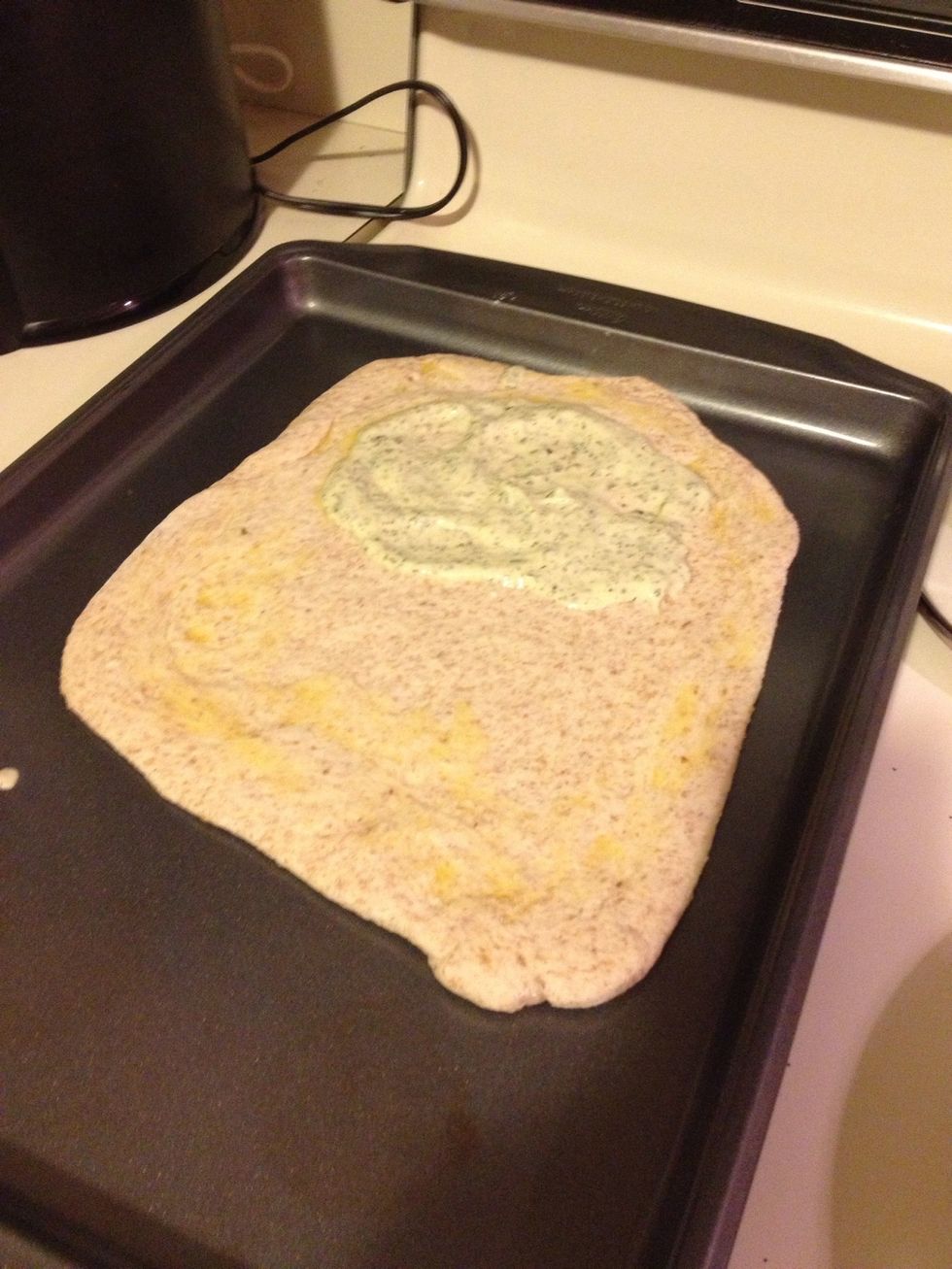 Once sauce and butter are completed, spread melted butter around outside surface of dough. Then spread sauce on half the dough. Make sure to leave 1 inch from surface of dough.