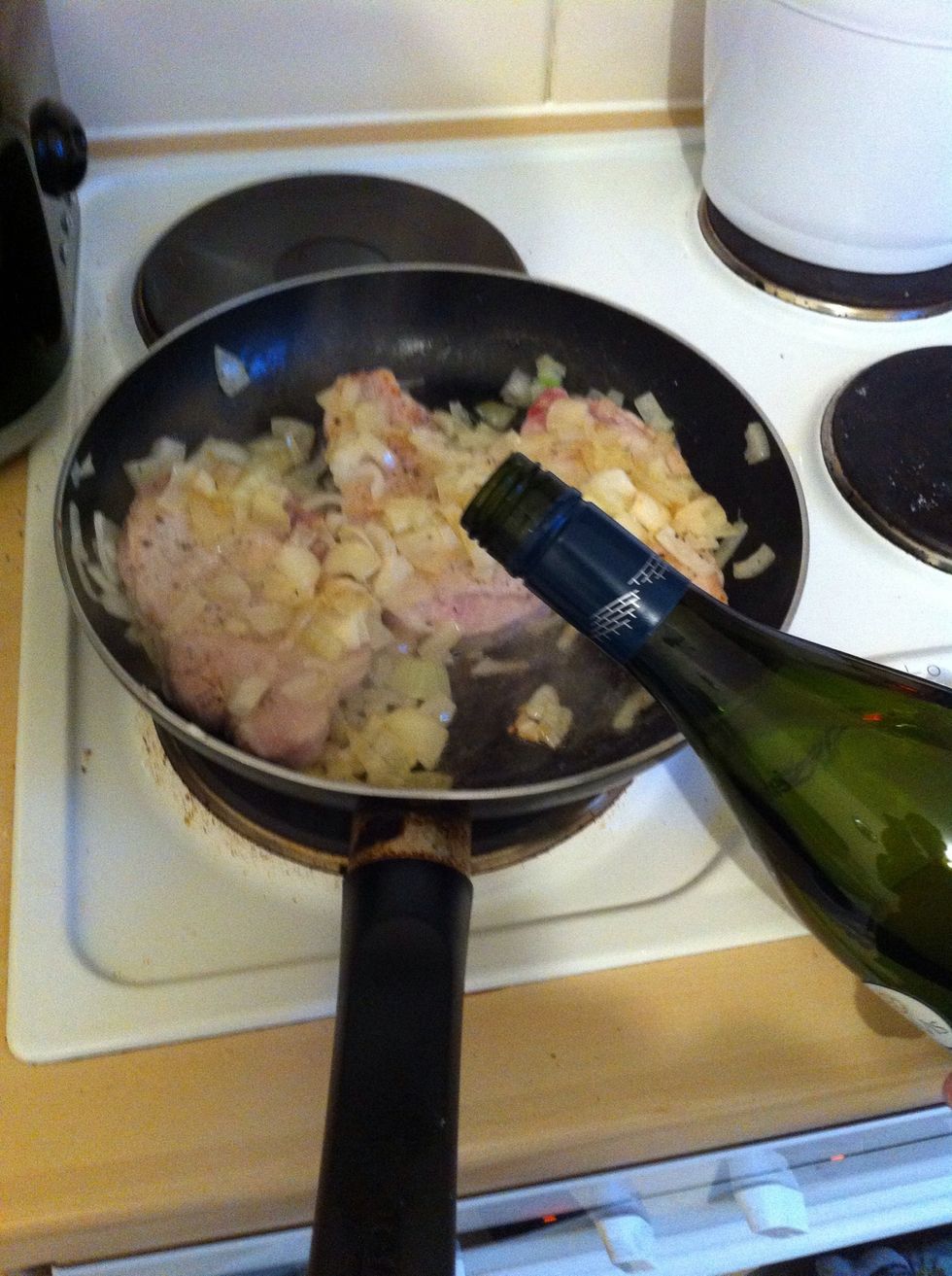 Once seared, add enough wine so the level covers the onions and about 3/4 the way up the chops