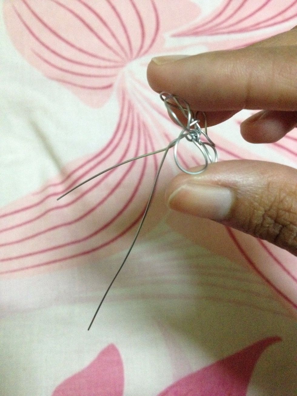Once shaping of the petals is done, twist the 2 ends of the wire to create a single stem to the flower.