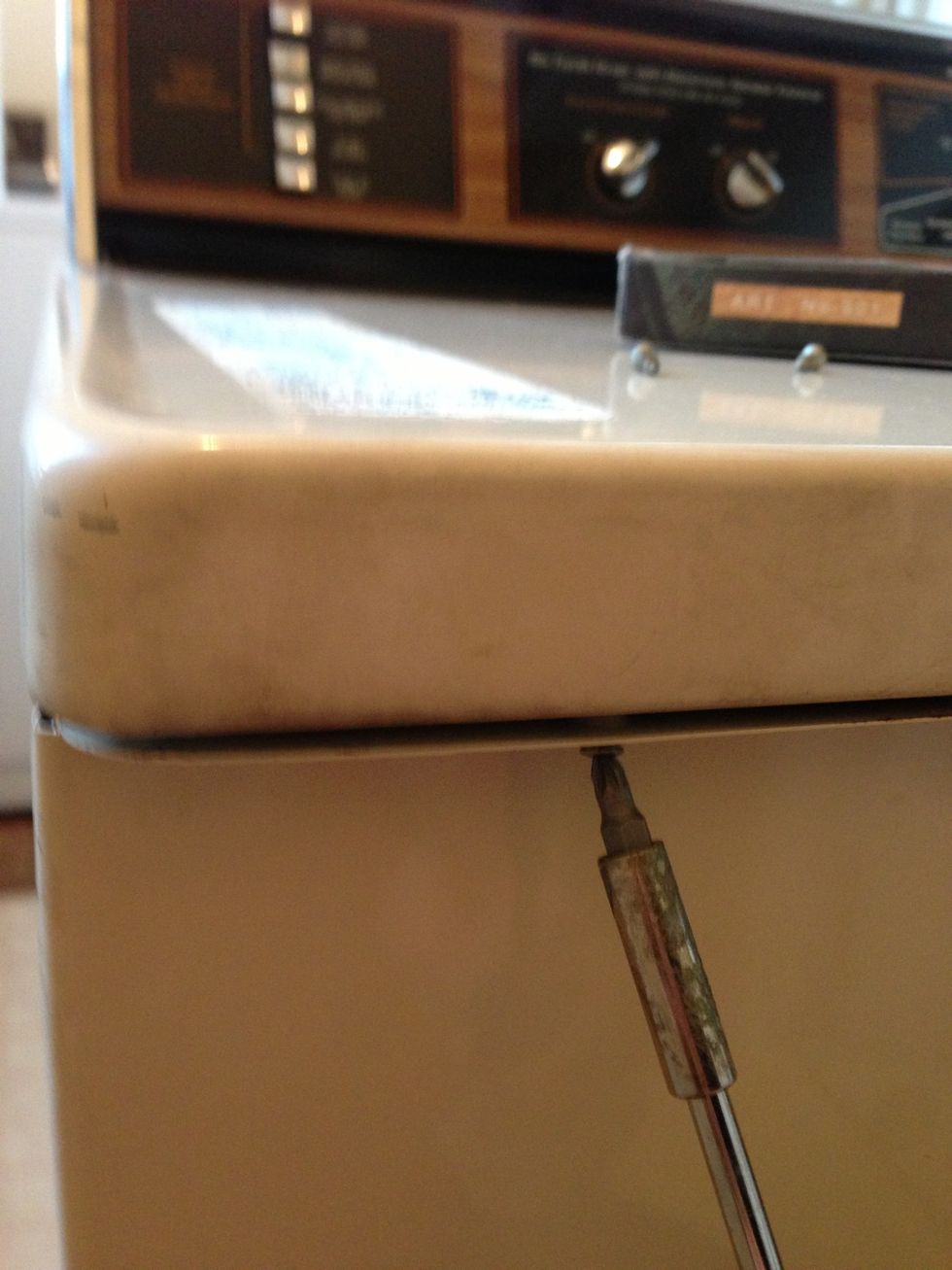 Once that's complete, reassemble the body of the machine. Start by screwing the sides together, then put the screws back into the underside of the lid.
