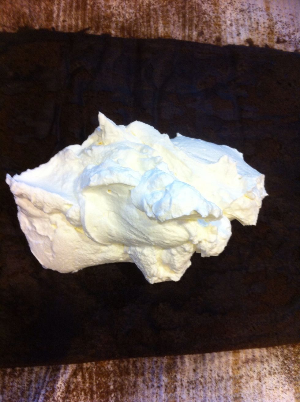 Once that's whipped up, I add a good dollop or two of my homemade marshmallow cream (from my s'mores bars). Or you can use store bought. Spread this around the roll and almost to the edges