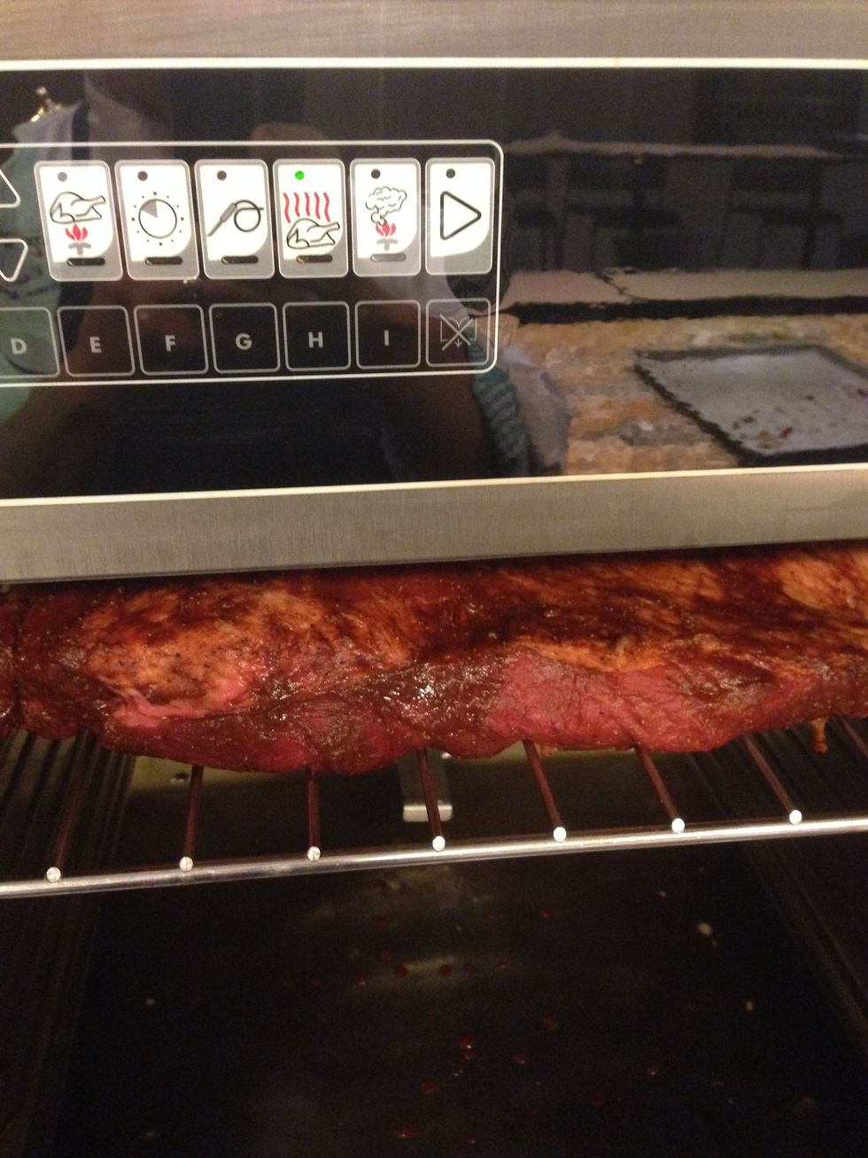 Once the 45 minute preheat is complete, load the racks of brisket into the oven, starting at the top slot and working your way down.