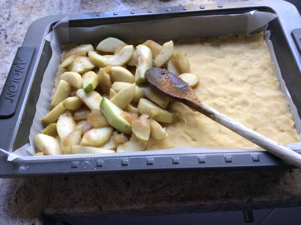 Once the apples are soft get out the pastry and smooth down on ball in a laming ton tray. Then spread the apples out on the pastry.