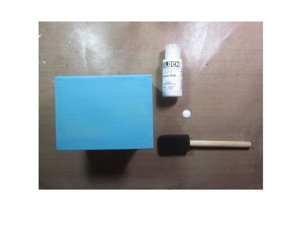Once the base coat is dry, lightly brush white paint over the surface.  You want a weathered wood look.
