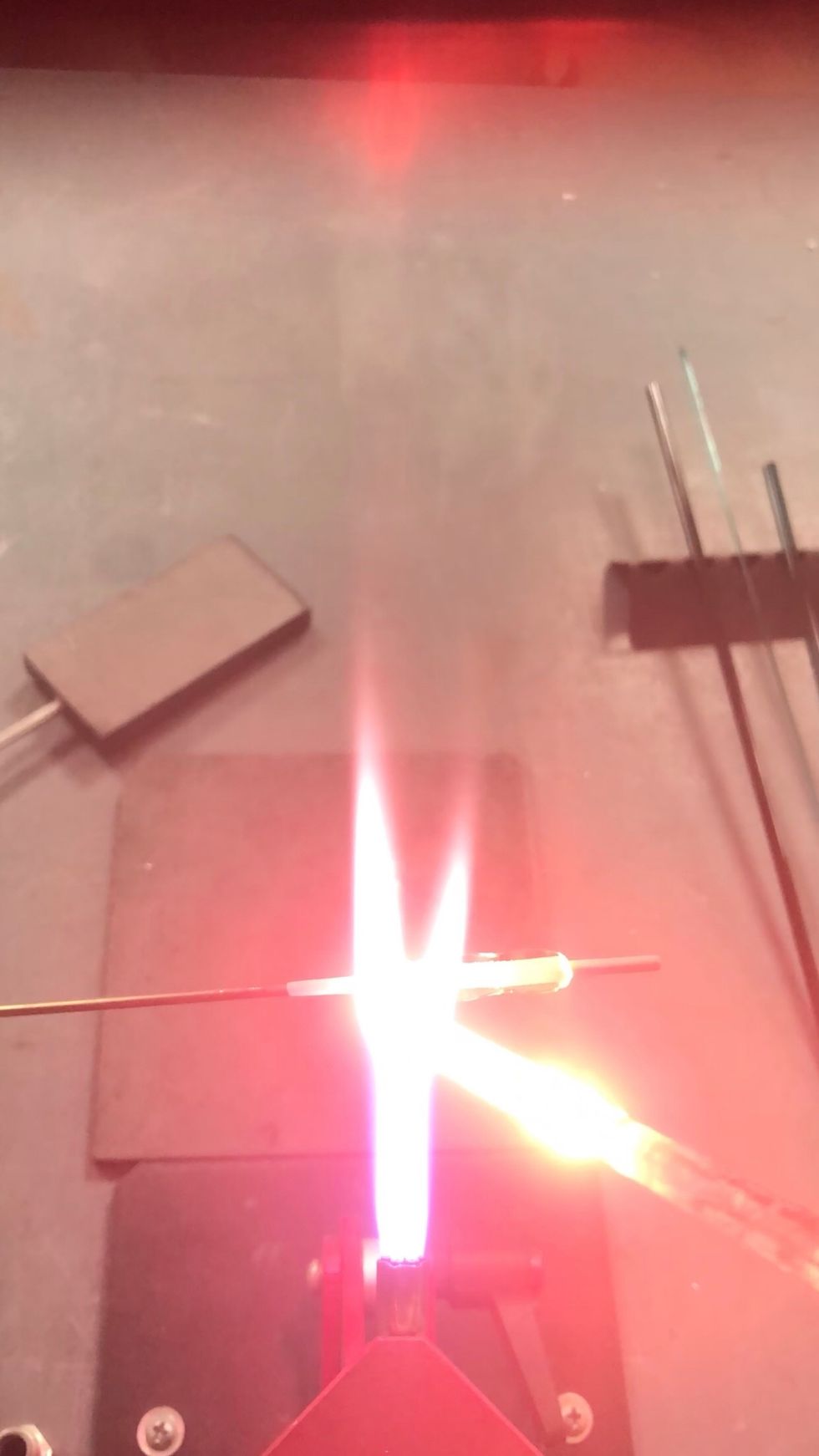 Once the bead\u2019s footprint has been established, build up both ends with a wrap of clear glass.