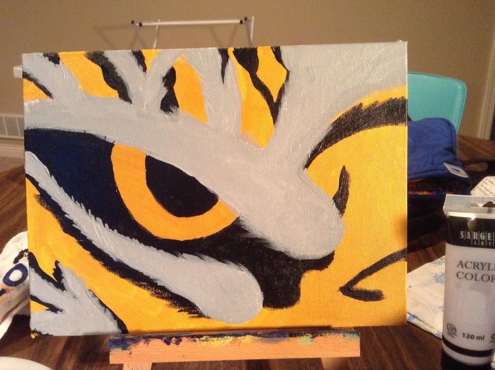 Once the black is dry, use gray (or make a gray with white and a minuscule drop of black) to fill in remaining areas. Create rough feathered edges as these are furry stripes!
