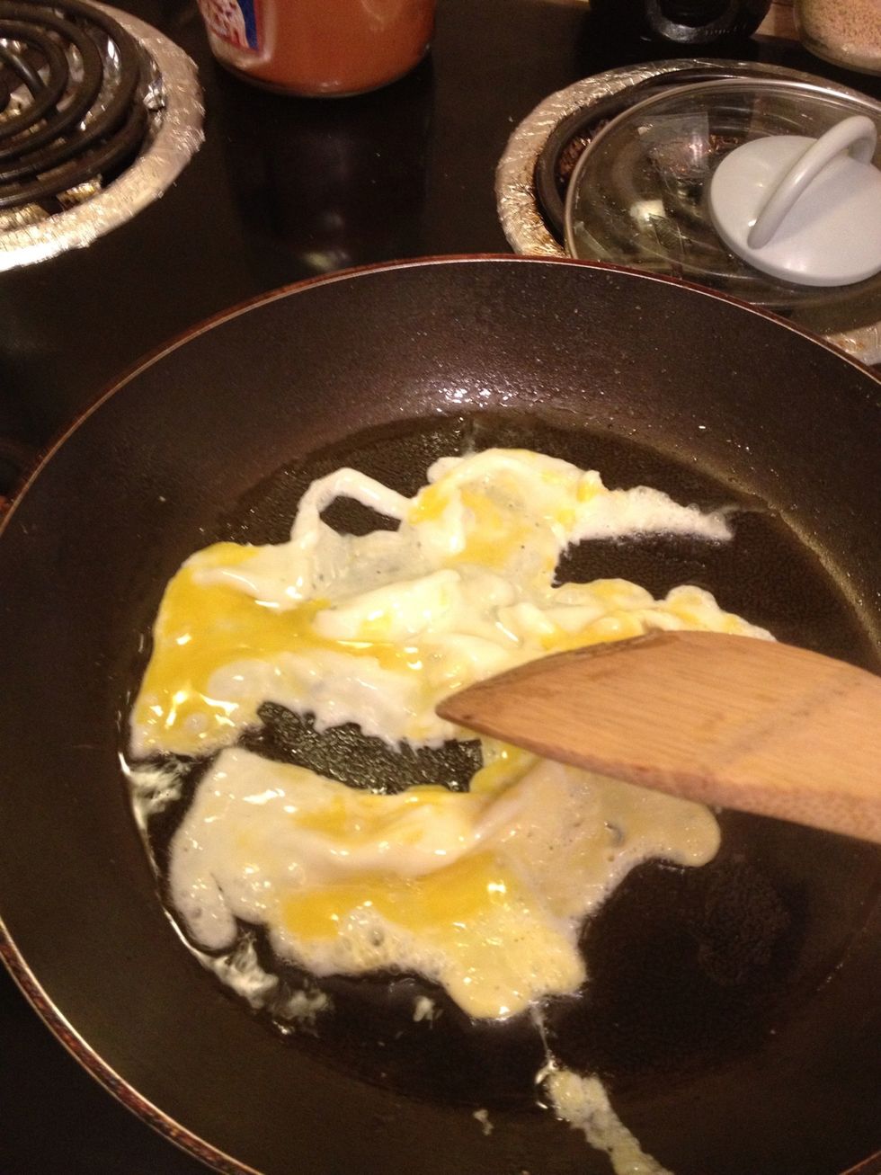 Once the bottom is no longer translucent, loosely cut up and toss the egg with a wooden spatula.